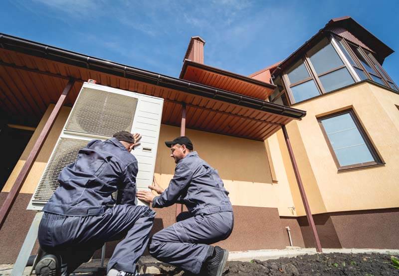 Hvac Technicians Servicing Home Heating And Cooling System